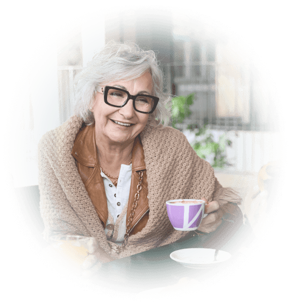 Senior woman having a cup of coffee on patio