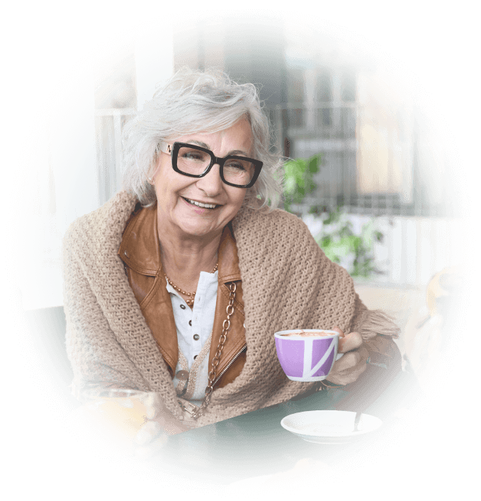 Senior woman having a cup of coffee on patio