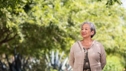 Senior walking in the garden while smiling