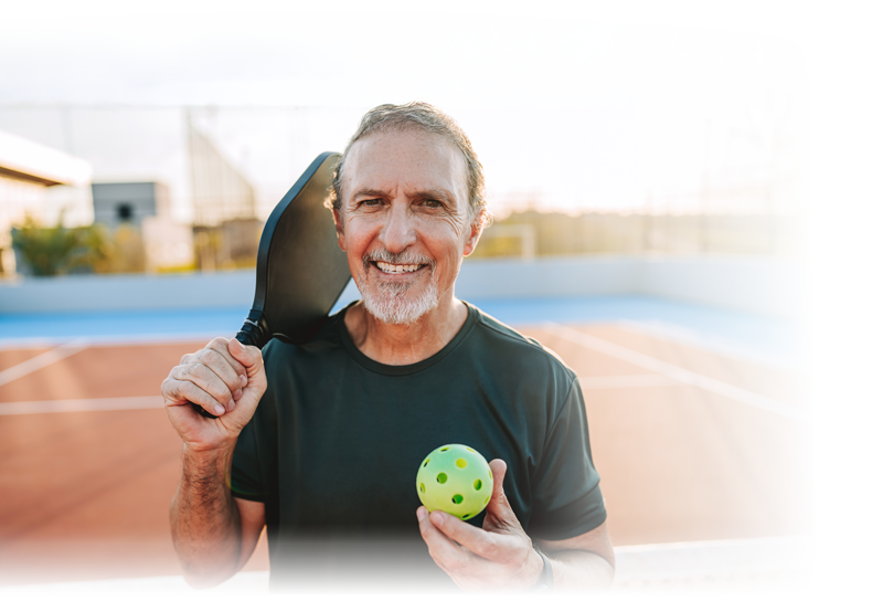 senior man playing pickleball