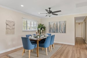 Dining room with blue chairs around a table in a Plymouth Village home
