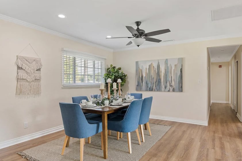 Dining room with blue chairs around a table in a Plymouth Village home