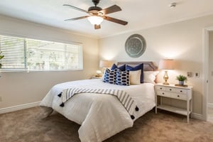 Bedroom with blue and white accent pillows in a Plymouth Village home