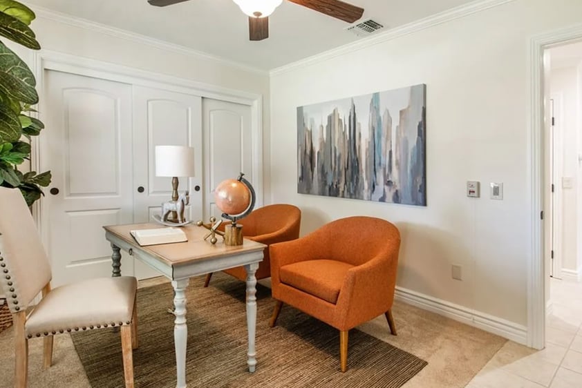 Office desk and chair with two orange armchairs in a Plymouth Village home