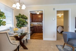 Dinette set with view through doors to galley kitchen and bedroom in a Plymouth Village home