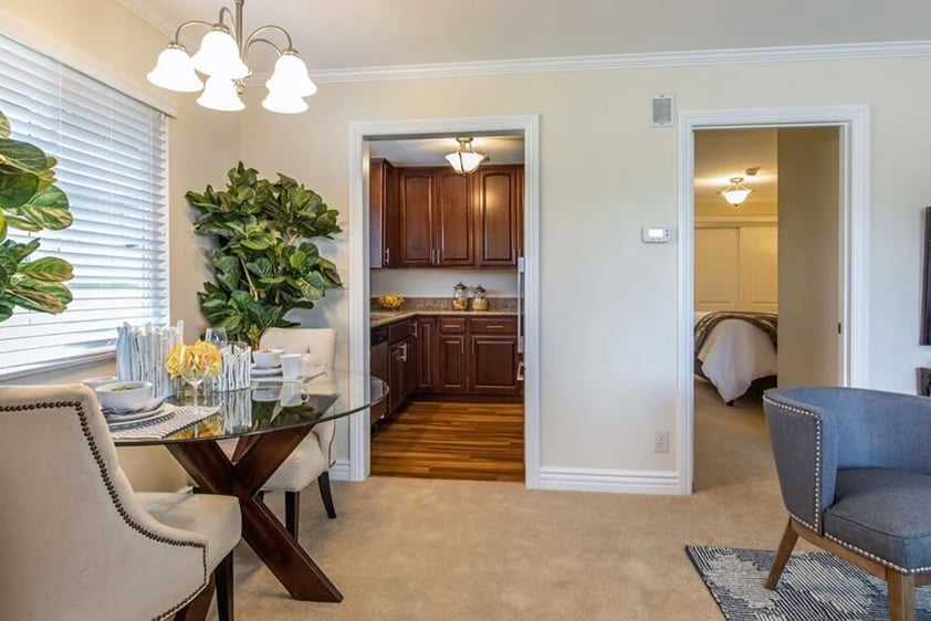 Dinette set with view through doors to galley kitchen and bedroom in a Plymouth Village home