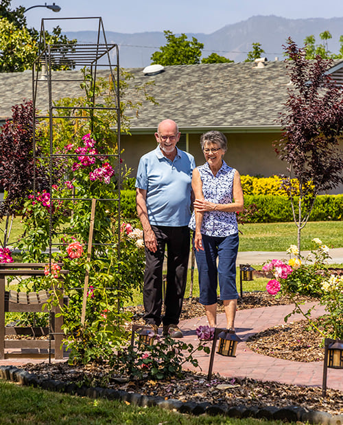 Senior man and woman in a garden at Plymouth Village