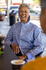 Senior woman having coffee downtown with a friend
