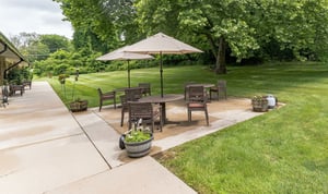 Outdoor patio with tables and umbrellas at Spring Mill Pointe