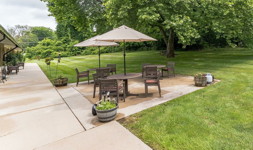 Outdoor patio with tables and umbrellas at Spring Mill Pointe