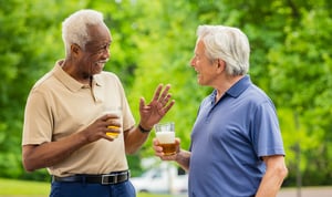 Two senior men having a conversation while drinking beer