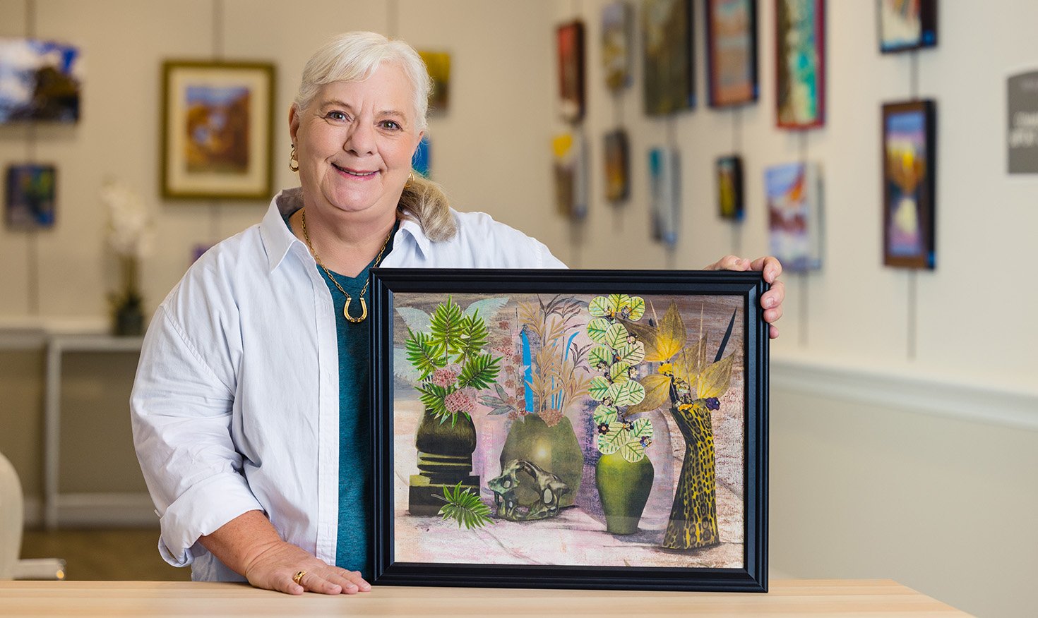 Senior woman displaying a piece of her artwork