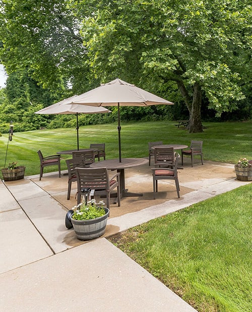 Outdoor patio with tables and umbrellas at Spring Mill Pointe