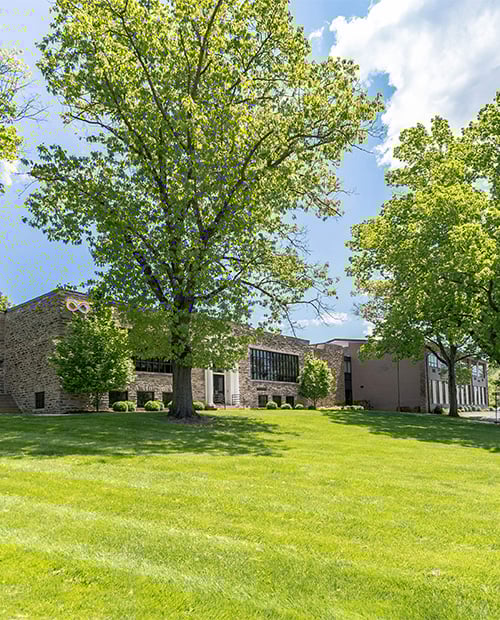 Spring Mill Pointe building and grounds with green grass and trees