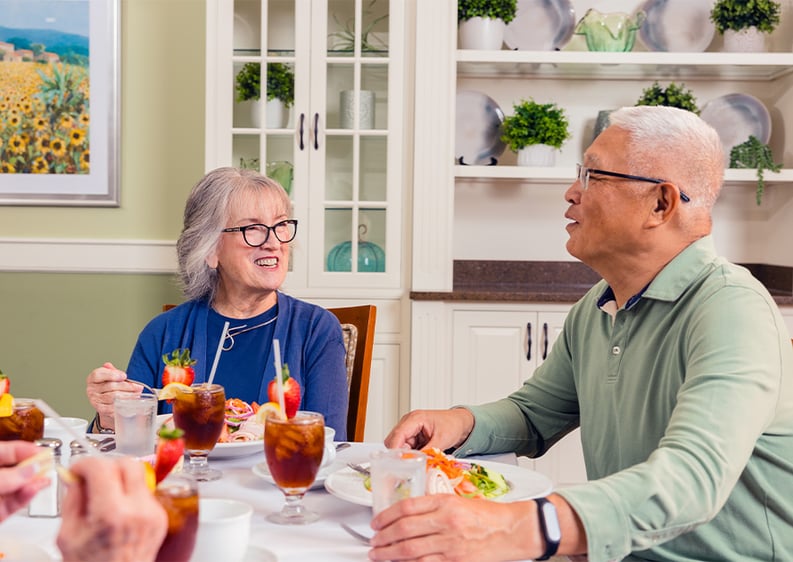 Senior man and woman having a meal in the Spring Mill Pointe dining room