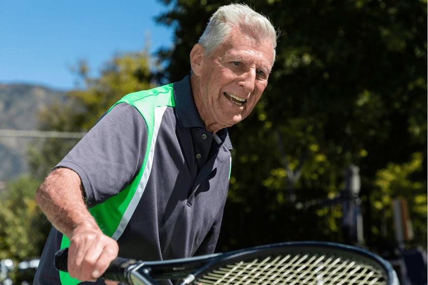 Senior man holding a tennis racket 