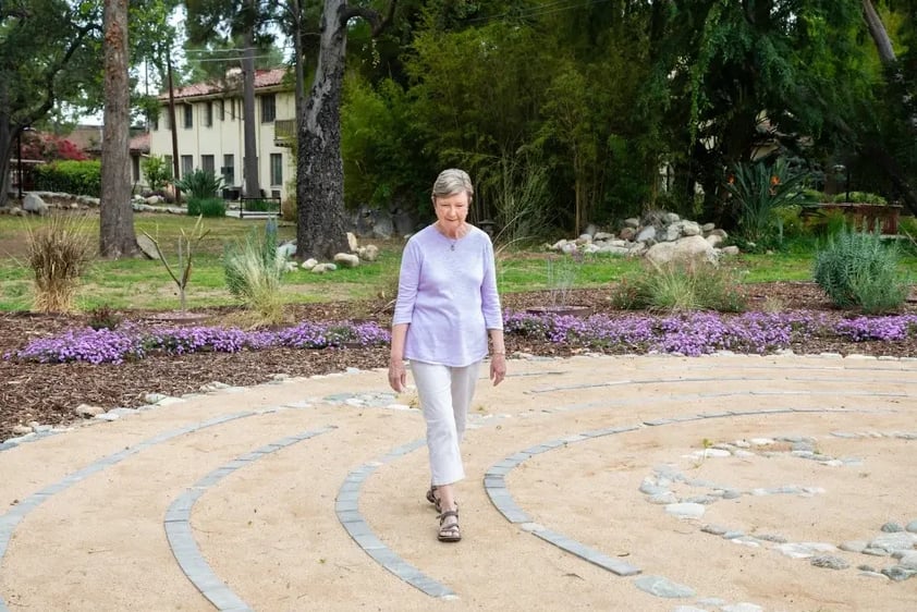 Senior woman walking through the labyrinth on the grounds of Westminster Gardens