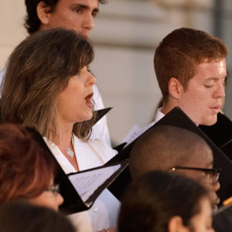 Group of people singing during a choir performance