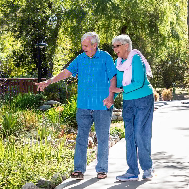 Senior couple walking on the grounds of Westminster Gardens