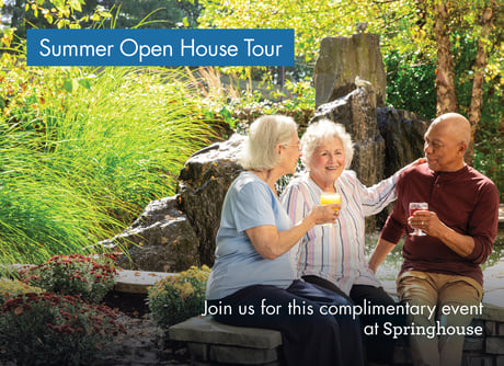 Three people toasting in a garden setting.