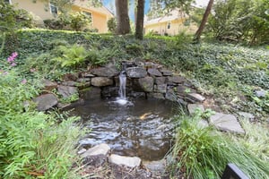 A small waterfall and pond at The Mansion at Rosemont