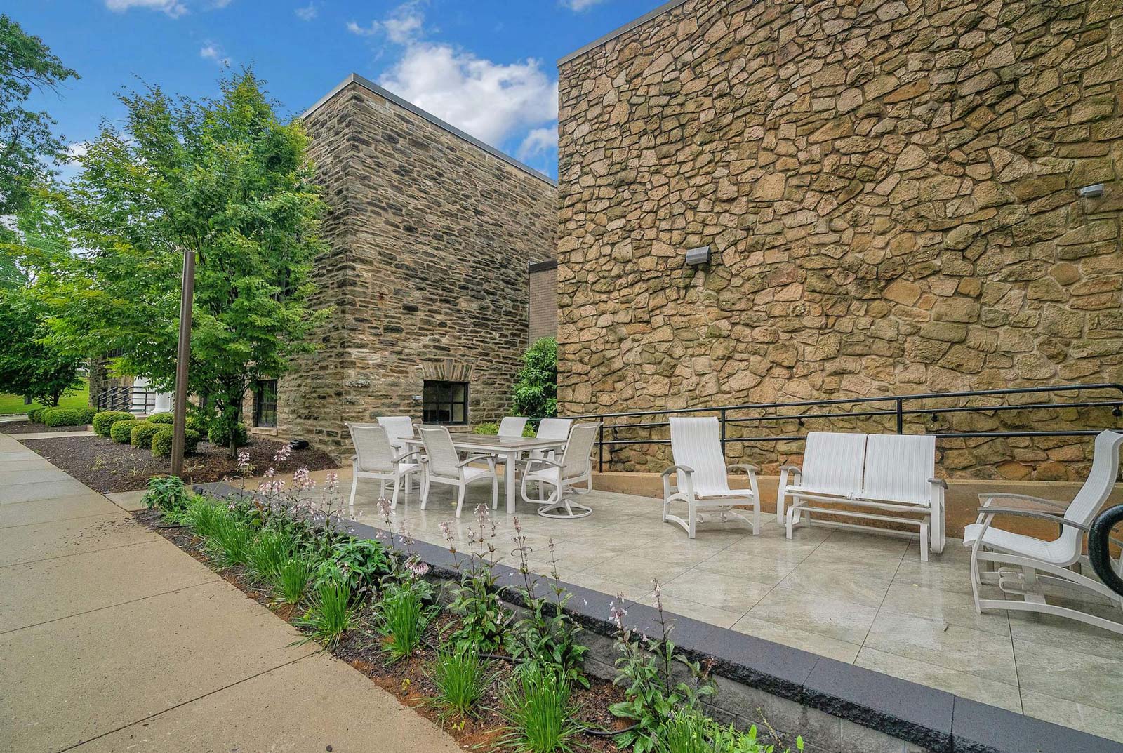 Spring Mill Pointe patio with tables, chairs, and rocking chairs