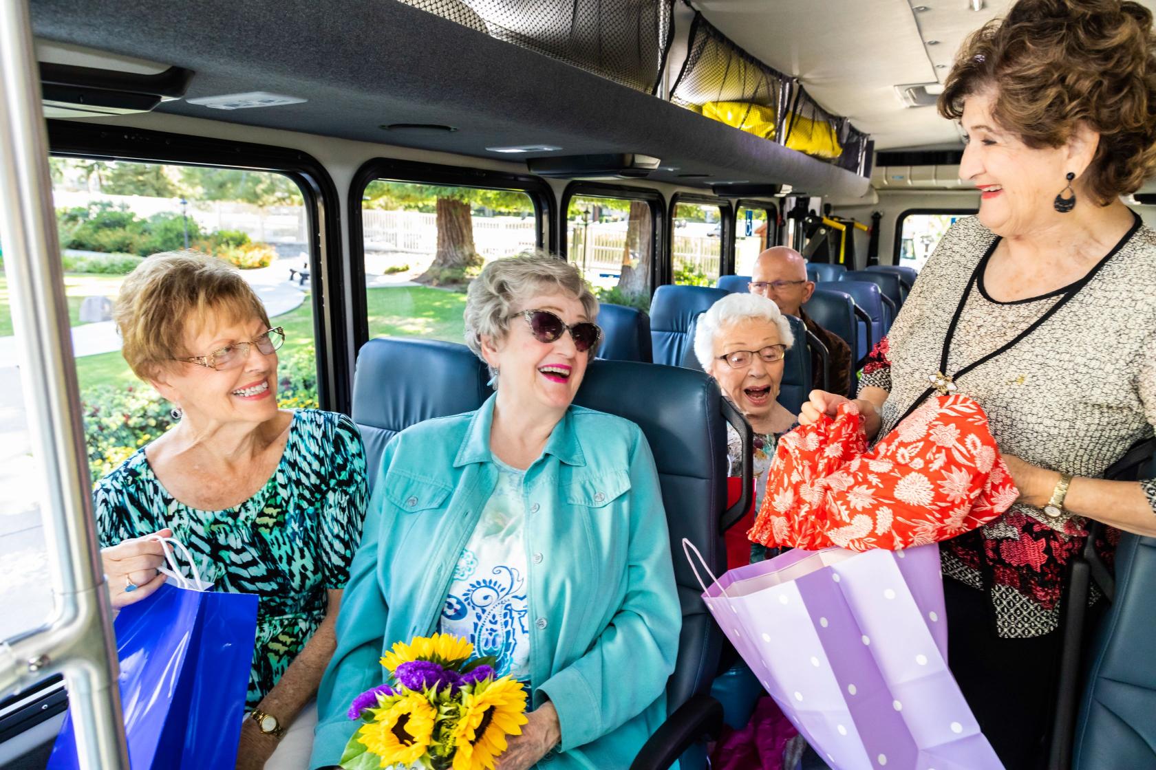 Ladies at the bus holding shopping bags