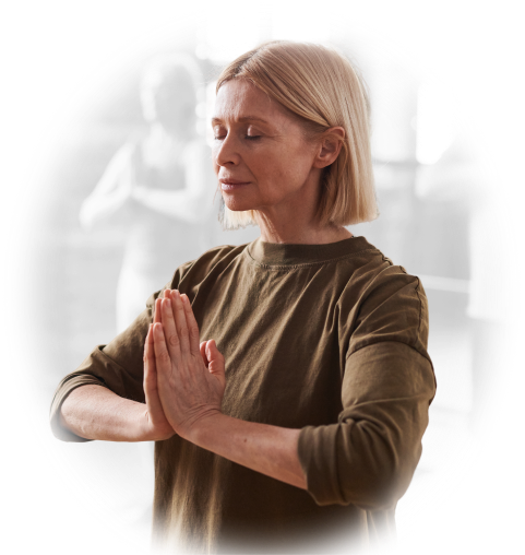 A woman with eyes closed holding a calm yoga pose.