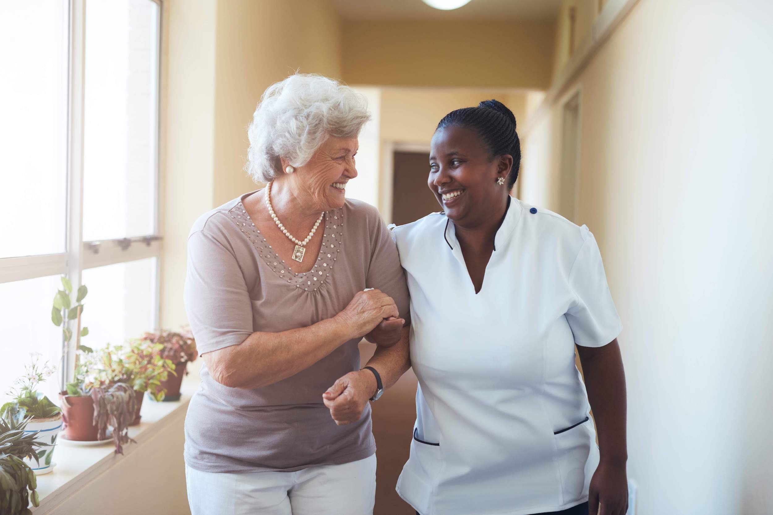 Nurse walking with woman