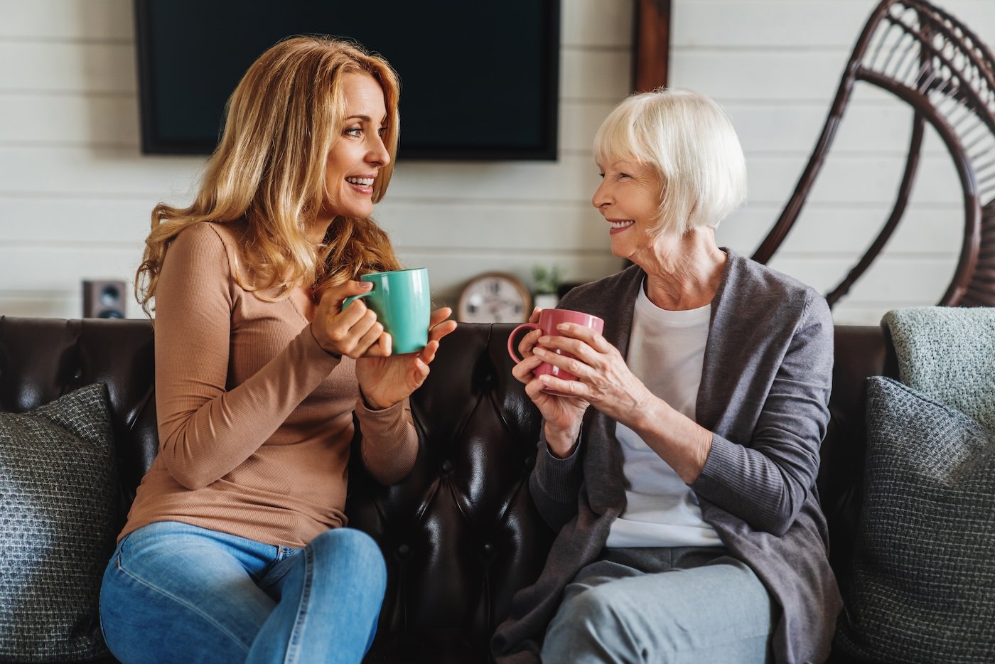Senior woman and her daughter drink coffee and have a healthy discussion about senior living options