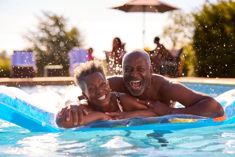 older couple smiling and embracing on a pool float