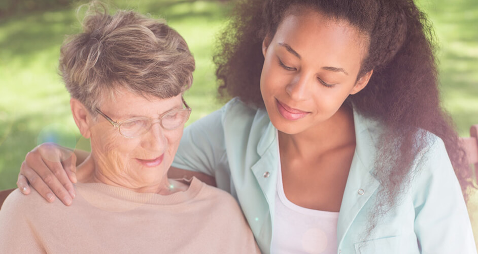 young woman embracing and listening to senior woman
