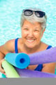 Bev in a pool with pool noodles