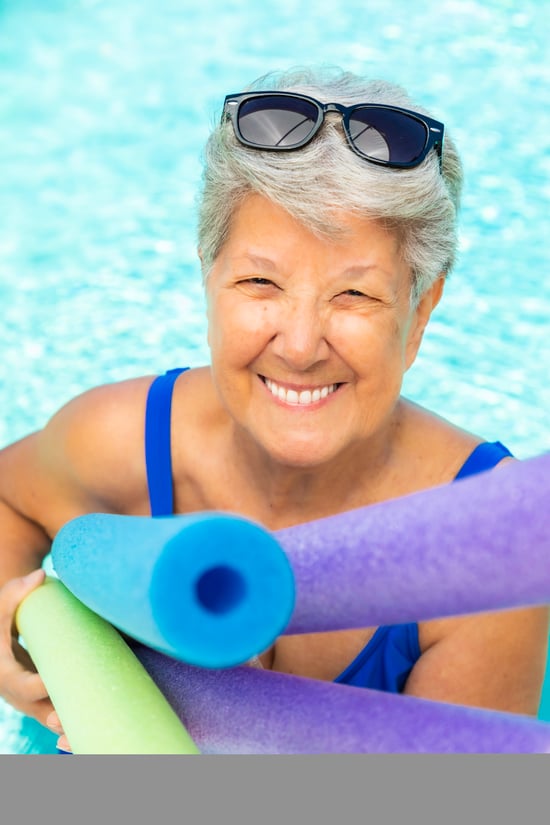 Bev in a pool with pool noodles