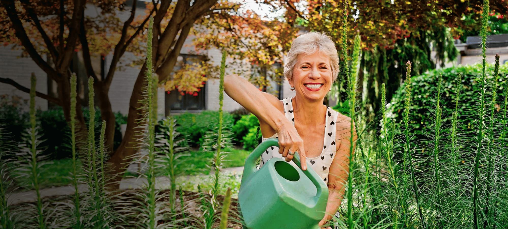 Lady smiling while taking care of the plants