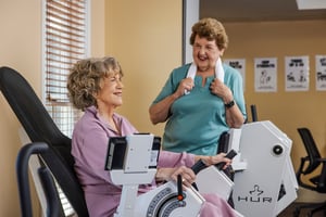 Two women working out in the fitness center at The Terraces at Los Altos