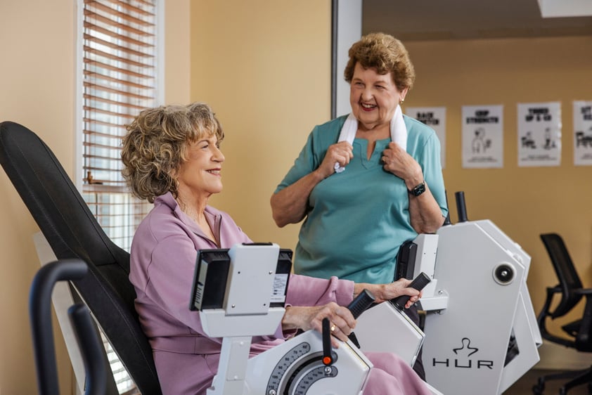 Two women working out in the fitness center at The Terraces at Los Altos