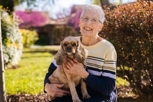 Lady holding her groomed dog
