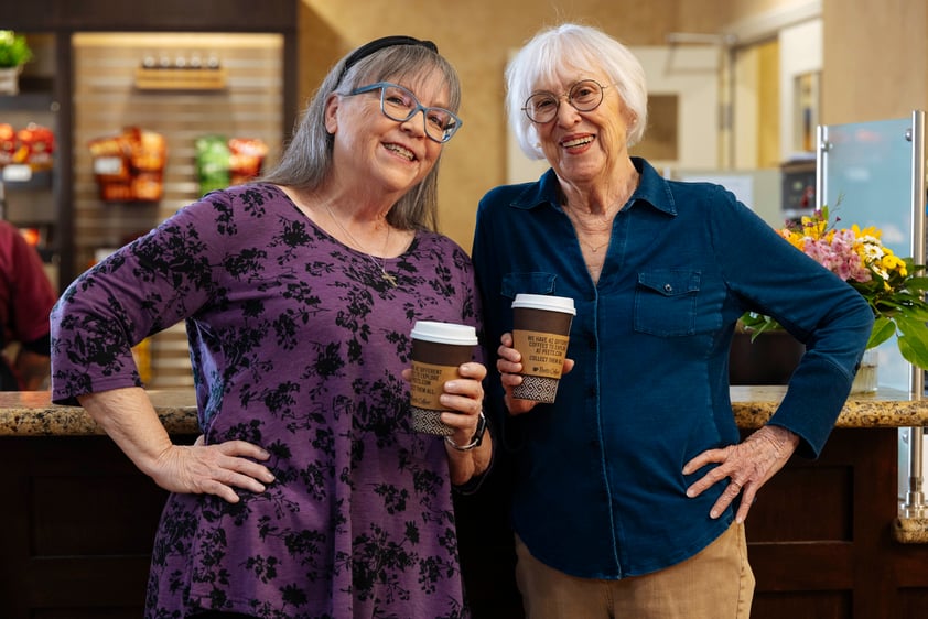 Two women with coffee cups