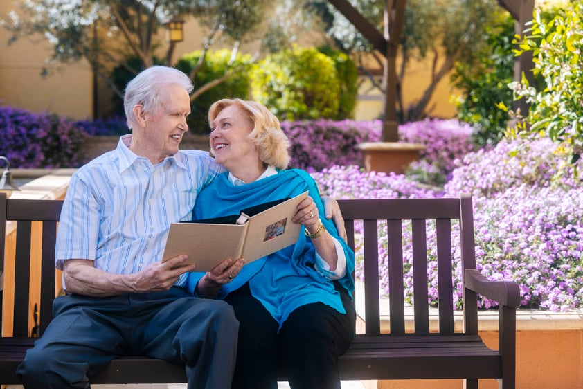 Couple reading a book on a bench