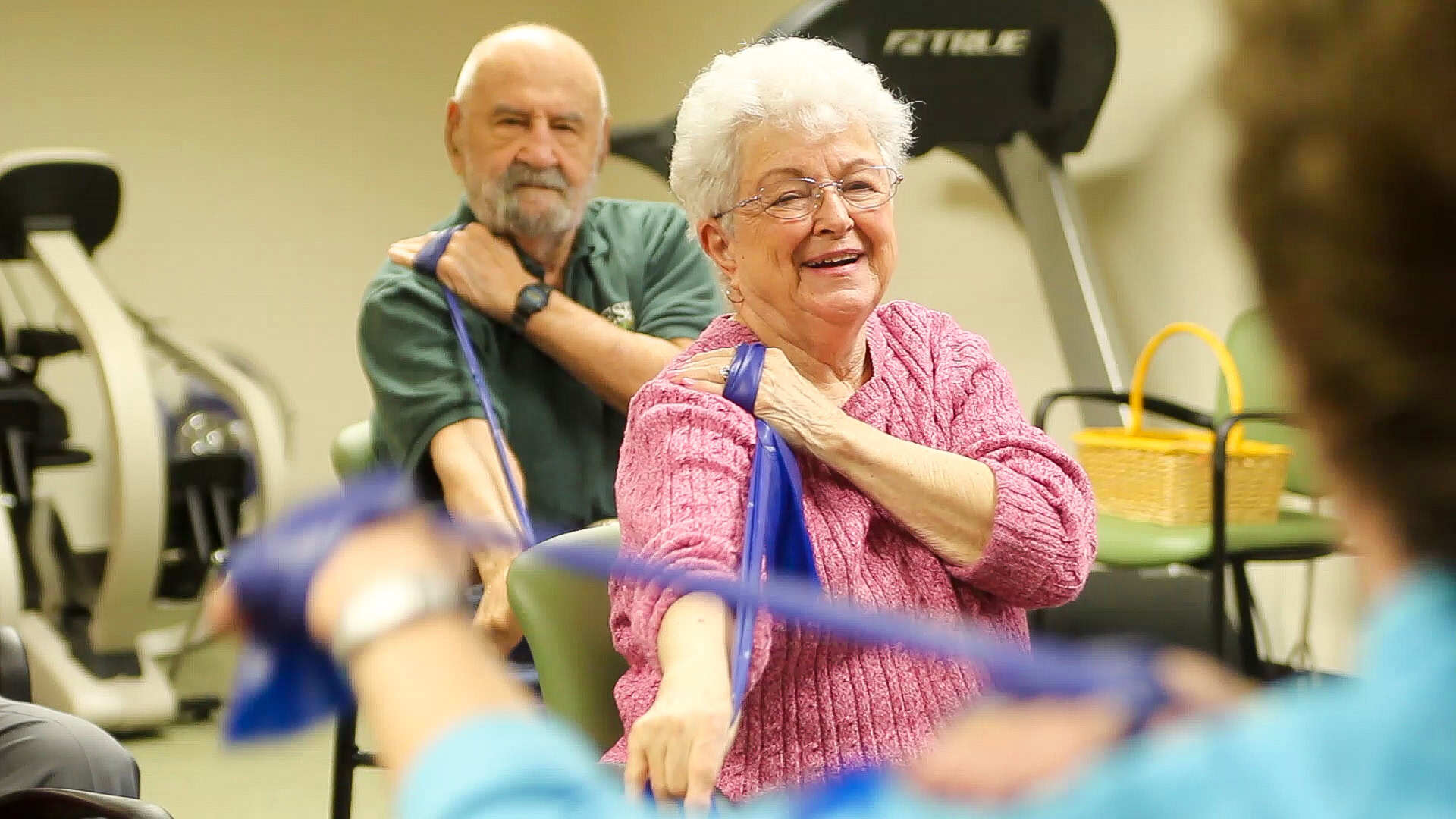 Man and woman using exercise bands