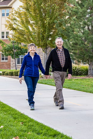 Happy senior couple walking outside