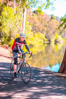 Senior man riding his bike by the water