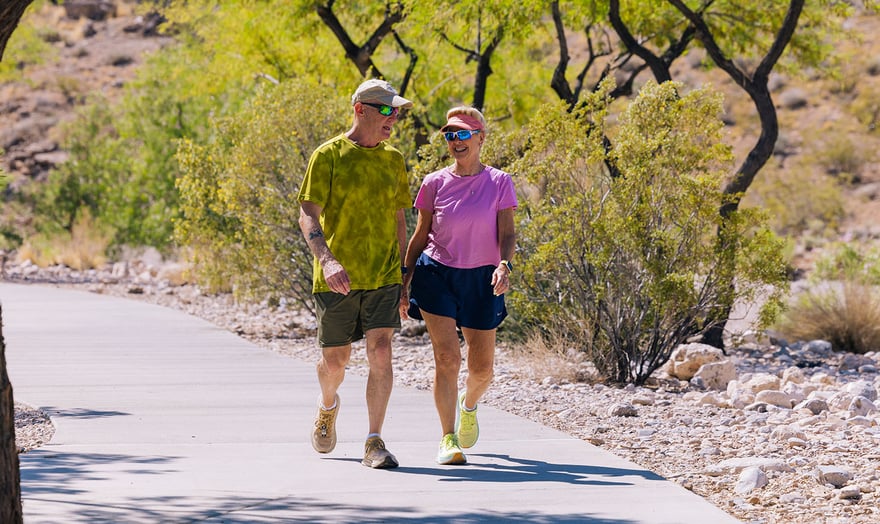seniors walking outside on walking trail