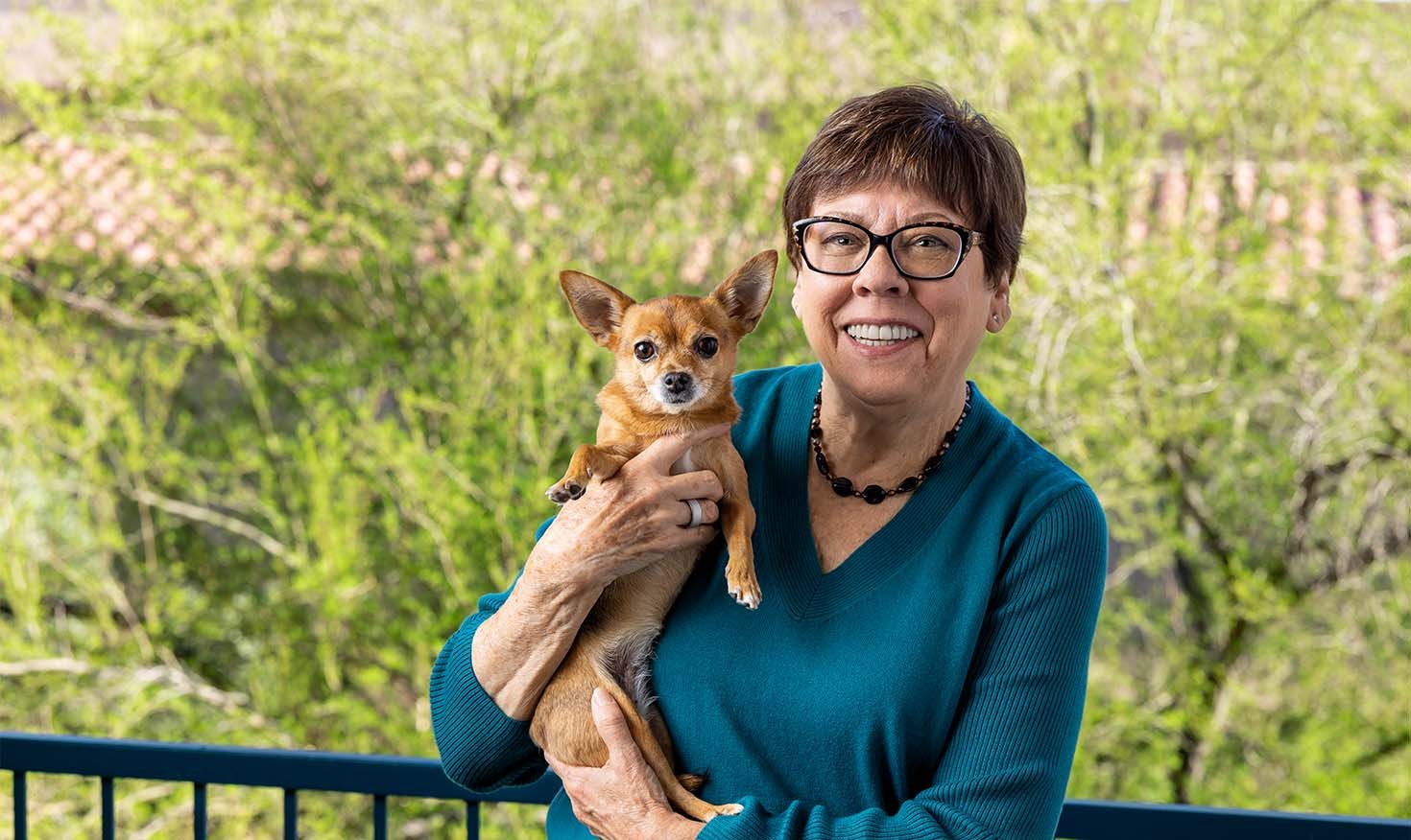 senior holding small dog