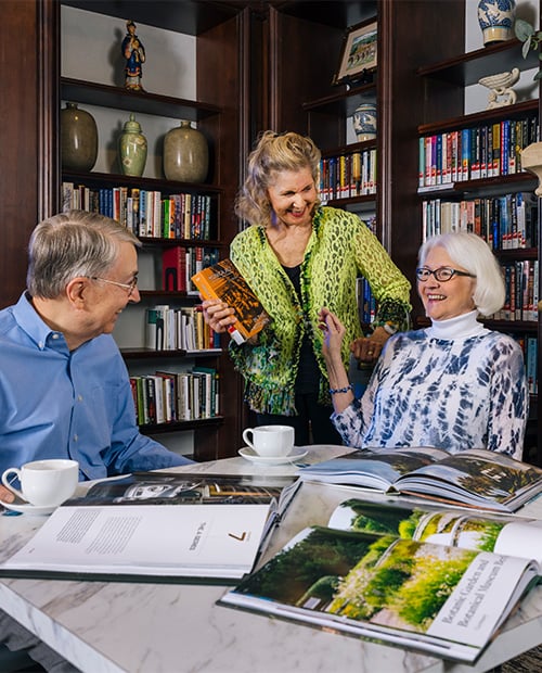 Seniors sipping coffee and reading books in the library