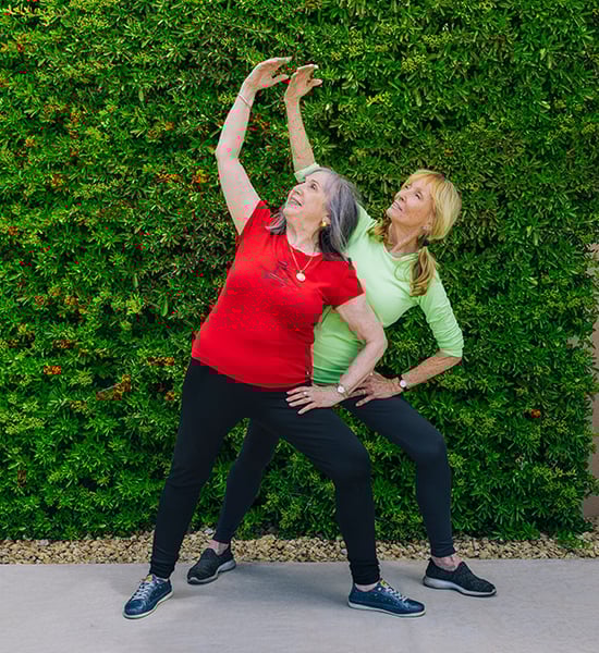 Mary with exercise coach doing stretches outside