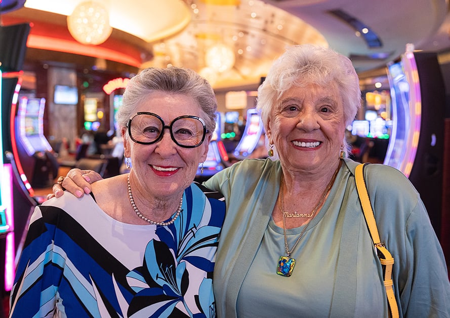 Two smiling senior women in a casino
