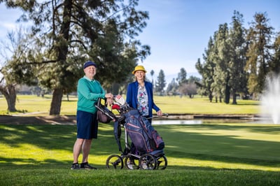 Dot and Bob walking on a golf course.
