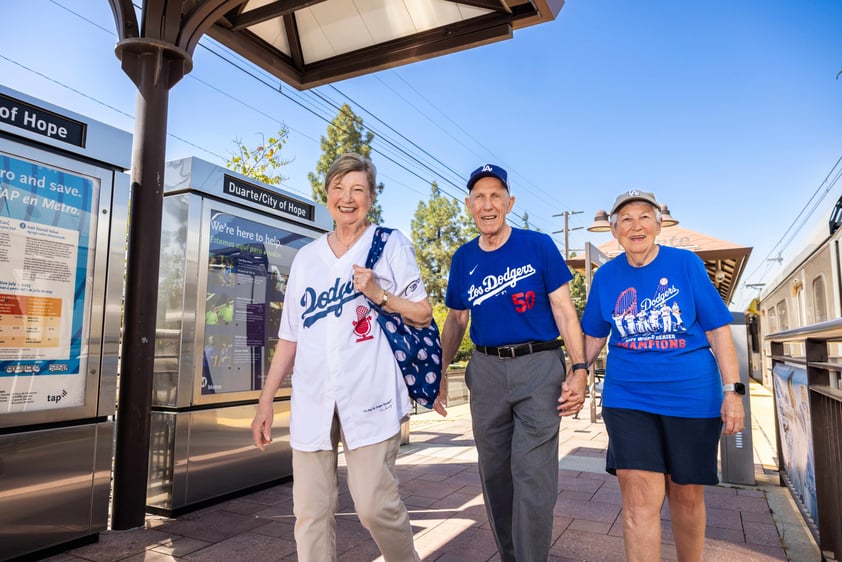 A man and two women wearing LA Dodgers gear